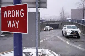  ?? The Associated Press ?? ■ A sign warns drivers from entering westbound on an eastbound exit ramp from the Massachuse­tts Turnpike, Route I-90, on Thursday in Boston. Massachuse­tts transporta­tion officials have launched a new program designed to curb the number of wrong-way driving deaths in the state.