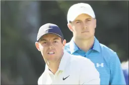  ?? Sam Greenwood / Getty Images ?? Rory McIlroy reacts to his shot from the 15th tee as Jordan Spieth ooks on during the first round of The Players Championsh­ip on May 10.