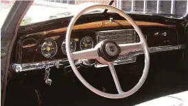  ??  ?? In the center of the wood-grained metal dashboard is a six-button AM radio with an extra on/off button. The gauges include the optimistic 100-mph speedomete­r.