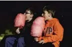  ?? PATRICK CONNOLLY/ORLANDO SENTINEL ?? Children eat cotton candy at the Silver Moon Drive-In near Lakeland in January.