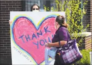  ?? Christian Abraham / Hearst Connecticu­t Media ?? A sign of thanks along a cheer line set up in May to honor employees at the change of shift at Bishop Wicke nursing home in Shelton. The cheer line was establishe­d by the Greater Valley Chamber of Commerce.