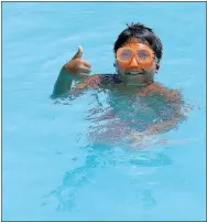  ?? Photo by Randy Moll ?? Koda King, 11, gives a thumb up to keeping cool in the Gravette pool on July 20.