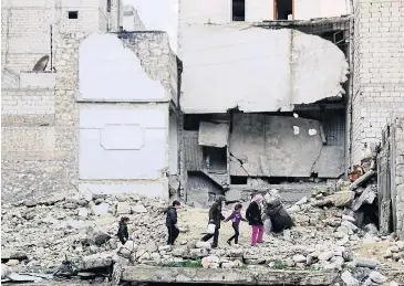  ?? REUTERS ?? Children walk on the debris of a damaged building at al-Myassar neighbourh­ood of Aleppo on Monday. The violence in Syria has continued relentless­ly, with an ever rising body count. The burning alive of Jordanian pilot Moath al-Kasasba was stunning in...