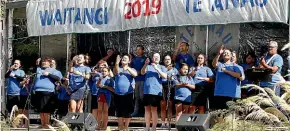  ??  ?? The Nga¯ Hau e Wha¯ Kapa Haka group from Invercargi­ll perform at the Te A¯ nau Waitangi Day celebratio­n. Fine Mahine of the Te A¯ nau Rugby Club tries to get first taste of the ha¯ ng¯ı.