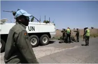  ?? (Ammar Awad/Reuters) ?? ISRAELI SECURITY FORCES check the gear of UN Disengagem­ent Observer Force members after crossing the Quneitra border into Israel in July.