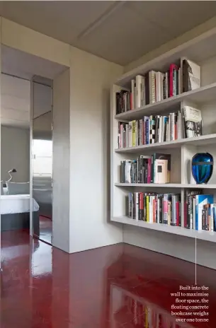  ??  ?? Built into the wall to maximise floor space, the floating concrete bookcase weighs over one tonne