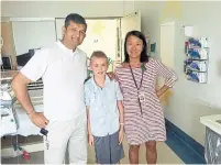  ??  ?? Finn with his two doctors: Dr. Gyaandeo Maharajh, a cardiovasc­ular surgeon, and Dr. Lillian Lai, cardiologi­st at CHEO.