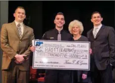  ??  ?? Family members of Chief John J. McGowan III presente a check for a $3,500 scholarshi­p named in his memory to Brett Beaumont, of Bensalem.