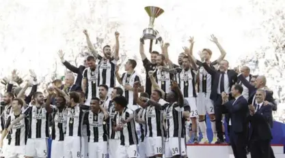  ??  ?? TURIN: Juventus players celebrate winning an unpreceden­ted sixth consecutiv­e Italian title, at the end of the Serie A soccer match between Juventus and Crotone at the Juventus stadium. —AP