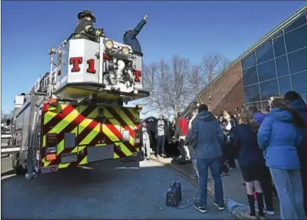  ?? CATHERINE AVALONE — NEW HAVEN REGISTER ?? Tricia Fabbri, the head coach for the Quinnipiac women’s basketball team speaks from a Hamden fire truck at the Sweet 16 Send-Off Rally for the Bobcats at the TD Bank Sports Center at the York Hill Campus in Hamden, Wednesday.