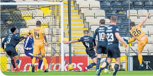  ??  ?? Skipper Craig Halkett fires home a shot to give Livingston an early lead which was undone by Dundee’s second-half revival