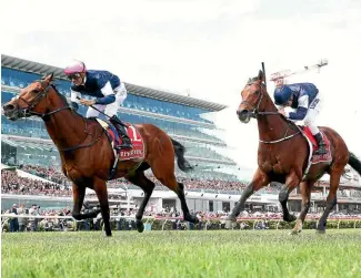  ?? PHOTO: GETTY IMAGES ?? Corey Brown on rekindling (outer) wears down Johannes Vermeer (Ben Melham) in the Melbourne Cup race at Flemington yesterday.