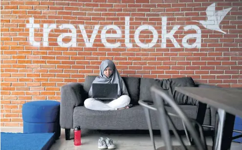  ?? REUTERS ?? A staff of Traveloka works at the company’s headquarte­rs in Jakarta.