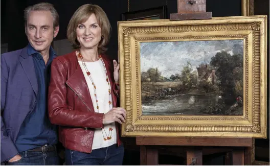  ??  ?? No fake: BBC presenters Philip Mould and Fiona Bruce with the £2 million painting Mr Mould sold in the 1990s for £35,000