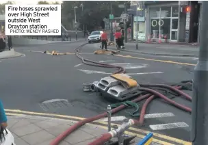  ??  ?? Fire hoses sprawled over High Street outside West Drayton station