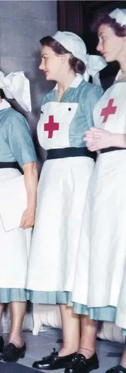  ??  ?? Left A model walks in front of Red Cross nurses in the frst Christian Dior show to be held at Blenheim Palace, in 1954. Above More looks from the autumn/winter 1954 collection