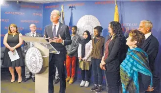  ?? JIM THOMPSON/ JOURNAL ?? Mayor Richard Berry announces a new Office of Immigrant and Refugee Affairs flanked by Highland High School students who are refugees and service providers.