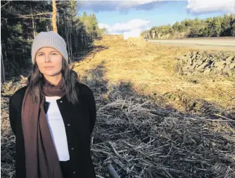  ?? ANDREW RANKIN/SALTWIRE NETWORK ?? Halifax resident Teresa Fisher is shown standing along Highway 102 where crews have been cutting further into the treeline. She calls the cutting excessive and is frustrated by the lack of public consultati­on.