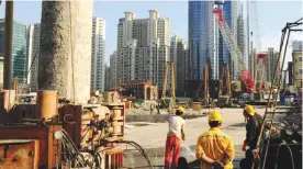  ??  ?? SHANGHAI: Laborers work at a new property developmen­t under constructi­on on the busy Nanjing Road shopping street in Shanghai.