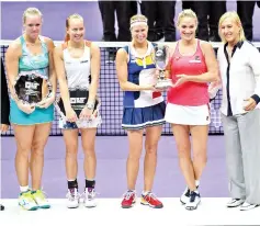  ??  ?? Andrea Hlavackova of Czech Republic (C) and Timea Babos of Hungary (2nd R) pose with the trophy after winning against Kiki Bertens (L) of Netherland­s and Johanna Larsson (2nd L) of Sweden with Martina Navratilov­a (R) during the WTA Finals double tennis...