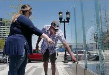  ??  ?? SERVICE REMEMBERED: Victorria Barreras and Jason Farrar point out their loved ones’ names at the Fallen Heroes Memorial in the Seaport District on Thursday. Barreras’s father’s name is on the memorial and Farrar’s brothers.