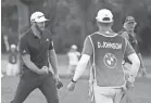  ?? BRIAN SPURLOCK/USA TODAY SPORTS ?? Dustin Johnson, left, reacts after making a long birdie putt on the 18th hole to send the BMW Championsh­ip into a playoff with Jon Rahm on Aug. 30.