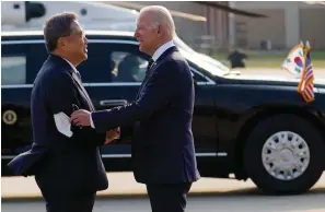  ?? The Associated Press ?? South Korean Foreign Minister Park Jin greets U.S.President Joe Biden as he arrives Friday at Osan Air Base in Pyeongtaek, South Korea.