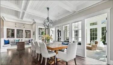  ?? METRO CREATIVE ?? Hanging a statement light and adding a centerpiec­e are ways to add appeal to your dining room.