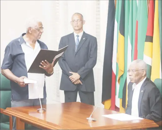  ?? (Photo by Keno George) ?? Desmond Trotman taking the oath of office as the newest member of the Guyana Elections Commission before President David Granger at State House yesterday