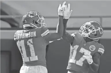  ?? JEFF ROBERSON/ AP ?? Wide receiver Demarcus Robinson celebrates a TD reception with wide receiver Mecole Hardman as the defending Super Bowl champion Chiefs have rolled to an 8-1 start.