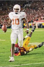  ?? Mike Blake/Reuters ?? Andre Ware, left, grew up wanting to play at Texas, but the Longhorns wanted to move the quarterbac­k into the secondary. Vince Young, a hot commodity at Madison, originally planned an H-Town takeover at UH.