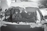  ?? Daniel Cole / Associated Press ?? A volunteer drives migrants to get tested for COVID in Briancon, France, so they can board trains.