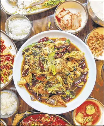  ?? REPRINTED FROM KOREATOWN. PHOTOGRAPH COPYRIGHT 2016 BY SAM HORINE ?? Sweet Soy-braised Chicken (Andong Jjimdak) can be found from Yet Tuh Korean Restaurant in Doraville.