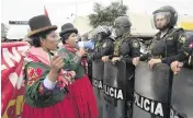  ?? MARTIN MEJIA AP ?? Anti-government Indigenous protesters shout at the police during a march against Peruvian President Dina Boluarte in Lima, Peru, on Wednesday.