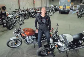  ?? MIKE DE SISTI / MILWAUKEE JOURNAL SENTINEL ?? Rod Copes, president of the Royal Enfield North American division, sits on a Royal Enfield INT 650 twin, next to a Continenta­l GT 650 twin, both new models, at the company’s warehouse on East Pittsburgh Avenue in Milwaukee.