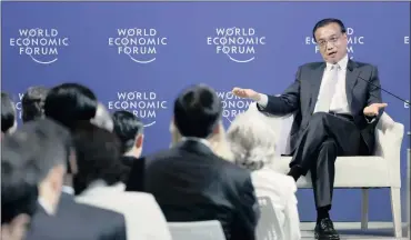  ?? PHOTO: REUTERS ?? China’s Premier Li Keqiang gestures as he answers a question during a meeting with executives from foreign companies at the World Economic Forum (WEF) in China’s port city Dalian yesterday. Li said the recent adjustment in the yuan was “very small”.