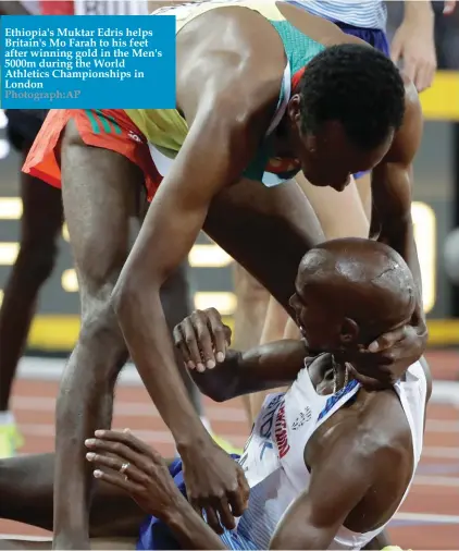  ??  ?? Ethiopia's Muktar Edris helps Britain's Mo Farah to his feet after winning gold in the Men's 5000m during the World Athletics Championsh­ips in London Photograph:AP