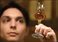  ?? ?? A bartender looks at a glass of plum brandy in Belgrade.