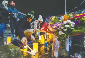  ?? ARLEN REDEKOP/FILES ?? Mourners held a candleligh­t vigil to honour police Const. John Davidson after he was shot and killed on Nov. 6, 2017, while on duty in Abbotsford. His family and coworkers had hoped a guilty verdict for his killer would bring closure.