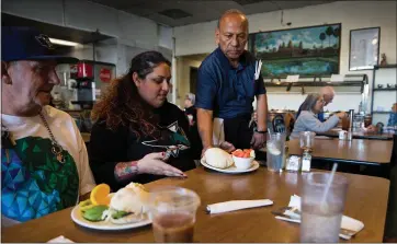  ?? RANDY VAZQUEZ — STAFF ?? Eddy T. and Jennifer Abraham receive their food at Minerva’s Restaurant in Fremont recently.