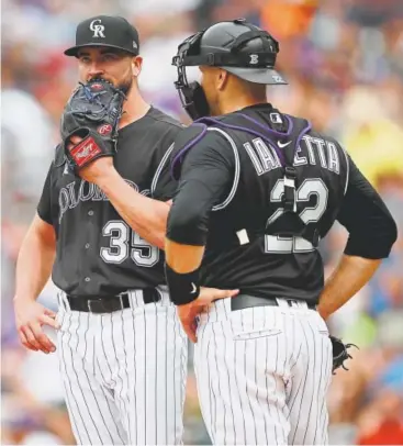  ?? David Zalubowski, The Associated Press ?? Rockies catcher Chris Iannetta, talking with starting pitcher Chad Bettis on Sunday, says a key of getting back on the winning track is not to “listen to anyone who’s saying negative things and people making a big deal about one facet of the game or another.”
