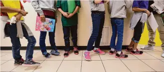  ?? Eric Gay/Associated Press ?? Migrant teens line up for a class at a “tender-age” facility for babies, children and teens, in Texas' Rio Grande Valley, in San Benito, Texas. The Biden administra­tion struggled to properly vet and monitor the homes where they placed a surge of migrant children who arrived at the U.S.-Mexico border in 2021, according to a federal watchdog report released Thursday.