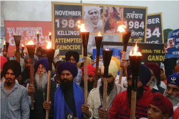  ?? — AFP photo ?? File photo shows Indian activists of the Dal Khalsa radical Sikh organisati­on marching at a protest to commemorat­e the 1984 anti-Sikh riots in Amritsar.