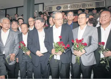  ?? APICHIT JINAKUL ?? Eight Pheu Thai Party politician­s pose for a photo at the Crime Suppressio­n Division where they answered criminal charges, that included sedition, after speaking out against the regime at a press conference last Thursday.