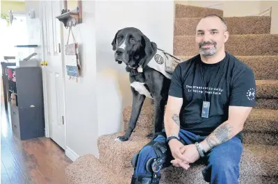  ?? MARLA BROSE/JOURNAL ?? Dale Fishgrab and his family, including his service dog Gunner, received a $7,500 Housing Assistance for Veterans grant intended for disabled post-9/11 veterans and active-duty service members whose homes require modificati­ons.