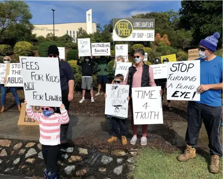  ??  ?? Placard-waving protesters wearing masks crashed the AGM of a Gold Coast private school for what they say is ‘a last stand’.