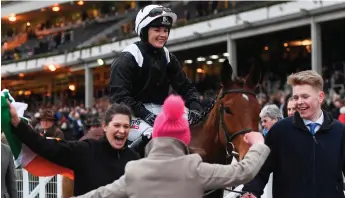 ?? SPORTSFILE ?? Katie Walsh is led into the winner’s enclosure at Cheltenham after victory aboard Relegate in the 2018 Bumper