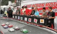  ??  ?? Kids take to the controls of a toy car race that was offered throughout the car show.