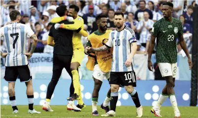  ?? ?? Left: Argentina’s Lionel Messi reacts after being beaten by Saudi Arabia at Lusail Stadium on Tuesday; Right: An anguished Argentine fan looks on at the venue in Doha after Argentina’s historic loss.