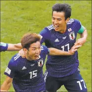  ?? Vadim Ghirda / Associated Press ?? Japan’s Yuya Osako, left, celebrates with Makoto Hasebe after Osako scored in Japan’s 2-1 win over Colombia at the World Cup on Tuesday in Saransk, Russia.